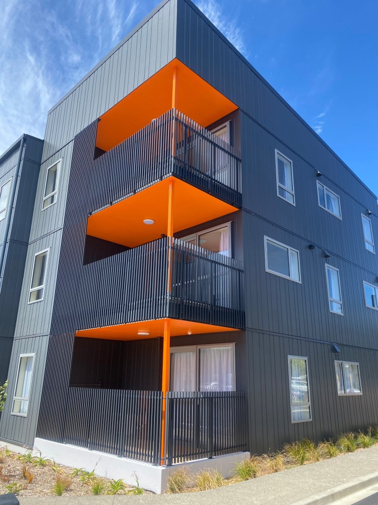 Bright orange premium expert powder coated poles and floors of the balcony of an architectural building